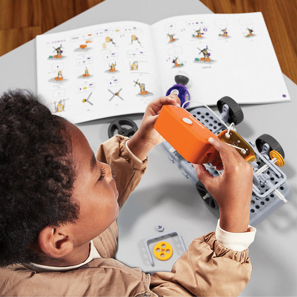 Child building a remote-control car from a Bubblegum STEM kit